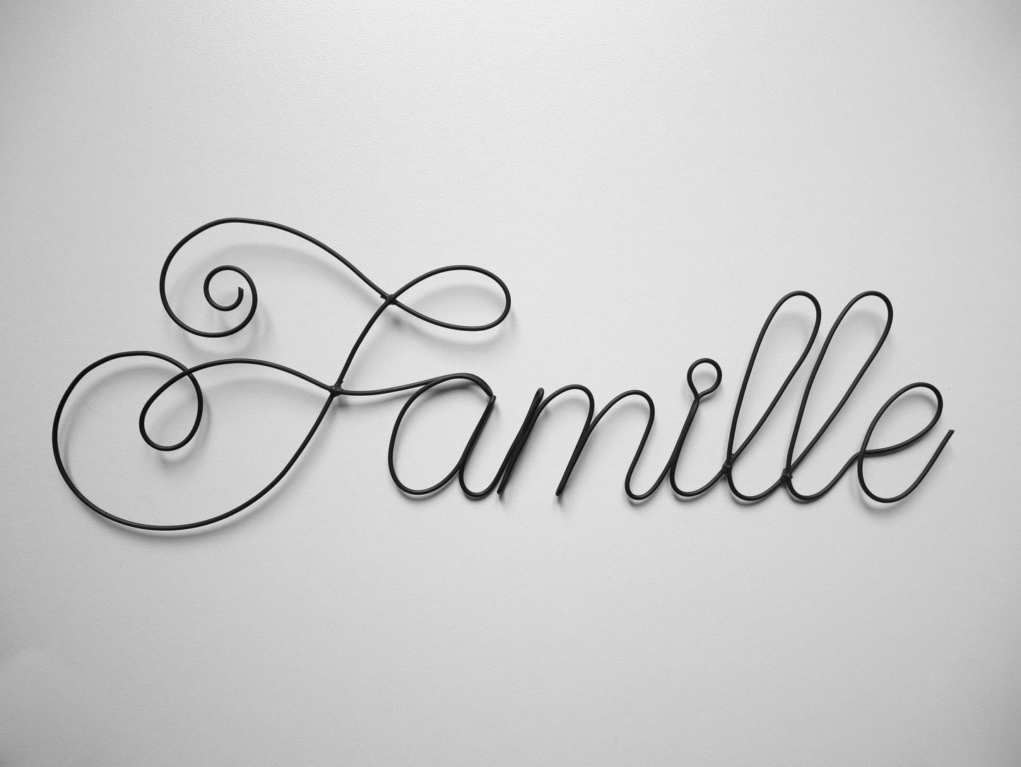 Word in annealed wire FAMILY, message, sentence, writing, quote, sculpture in annealed wire, wall decoration, plate stickers